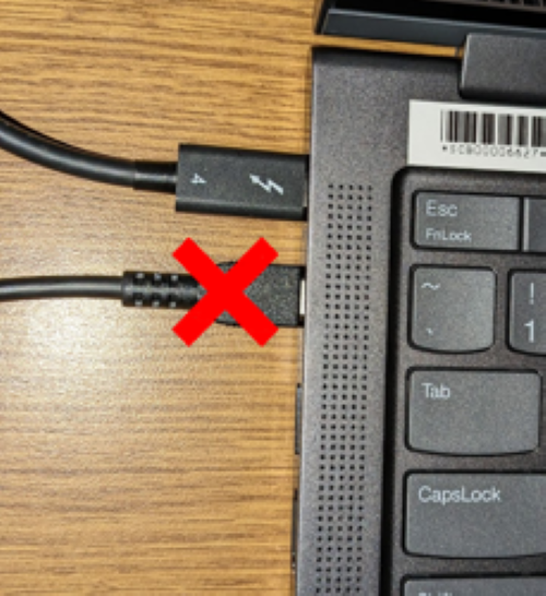 The power cable and dock cable plugged in with a large red X over the dock cable