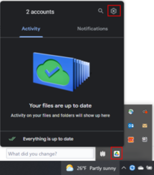 The system tray with the google drive icon and the gear settings icon highlighted in red